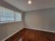 Bedroom featuring hardwood floors, neutral paint, and a large window at 3796 Leesburg Sw Ct, Atlanta, GA 30331
