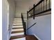 Bright entryway with wood stairs and a dark railing leading to the upper level at 3796 Leesburg Sw Ct, Atlanta, GA 30331
