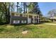 Traditional two-story home with a gray brick facade, white trim, and a spacious front yard at 3796 Leesburg Sw Ct, Atlanta, GA 30331