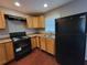 Kitchen featuring wood cabinets, laminate countertops, and modern black appliances at 3796 Leesburg Sw Ct, Atlanta, GA 30331