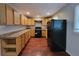 Functional kitchen with wood cabinets, laminate countertops, and modern black appliances at 3796 Leesburg Sw Ct, Atlanta, GA 30331