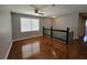 Loft area with hardwood floors, a ceiling fan, and a staircase with a modern railing at 3796 Leesburg Sw Ct, Atlanta, GA 30331