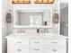 Elegant bathroom featuring double sinks with marble countertops, and decorative lighting at 1194 Grandview Cir, Powder Springs, GA 30127