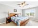 A bright bedroom showcases a wooden bed frame, soft carpeting, and a window with a view at 1194 Grandview Cir, Powder Springs, GA 30127