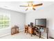 Bedroom featuring a ceiling fan, desk with computer, window and a display case at 1194 Grandview Cir, Powder Springs, GA 30127