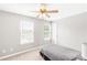 Carpeted bedroom with neutral walls featuring a ceiling fan, windows and a small bed at 1194 Grandview Cir, Powder Springs, GA 30127