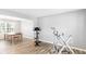 Bonus room featuring exercise equipment, neutral paint, and a view into an adjacent dining area with a wood table at 1194 Grandview Cir, Powder Springs, GA 30127