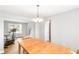 Dining area featuring a wood table, chandelier, neutral paint, and a view of additional exercise equipment at 1194 Grandview Cir, Powder Springs, GA 30127