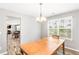 Bright dining area features a chandelier, wood table, and an open view of the living room and fireplace at 1194 Grandview Cir, Powder Springs, GA 30127