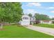 Beautiful two-story house with manicured lawn, driveway, a two-car garage and mature trees at 1194 Grandview Cir, Powder Springs, GA 30127