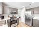 Spacious kitchen boasts stainless steel appliances, ample counter space, and sleek gray cabinets for a contemporary feel at 1194 Grandview Cir, Powder Springs, GA 30127