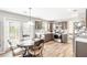 Modern kitchen with stainless steel appliances, granite countertops, and an adjoining dining area at 1194 Grandview Cir, Powder Springs, GA 30127