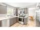 Modern kitchen with stainless steel appliances, gray cabinets and light countertops, offering both style and functionality at 1194 Grandview Cir, Powder Springs, GA 30127