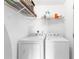 Laundry room featuring a side-by-side washer and dryer with a wire shelf above at 1194 Grandview Cir, Powder Springs, GA 30127