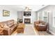Cozy living room with fireplace, ceiling fan, plush sofas, and lots of natural light at 1194 Grandview Cir, Powder Springs, GA 30127