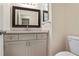 Bathroom with a gray vanity, granite countertop and a dark framed mirror at 1284 Brandl Dr., Marietta, GA 30008