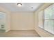 Bright dining room featuring neutral walls, new flooring and natural light from the large window at 1284 Brandl Dr., Marietta, GA 30008