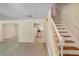 View of the spacious living room, staircase, and kitchen featuring neutral walls and wood look floors at 1284 Brandl Dr., Marietta, GA 30008