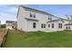 New construction home backyard includes green grass, small patio, and fence line at 1640 Tide Mill Rd, Cumming, GA 30040