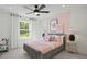 Bright bedroom with soft pink accents, a plush bed, and a sunny window overlooking the landscape at 1640 Tide Mill Rd, Cumming, GA 30040