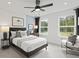 Charming bedroom featuring a ceiling fan, stylish decor, and a window with a view of lush greenery at 1640 Tide Mill Rd, Cumming, GA 30040