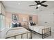 Shared bedroom featuring twin beds, neutral decor, and an overhead fan at 1640 Tide Mill Rd, Cumming, GA 30040