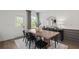 Elegant dining room featuring a wood table, black chairs, and modern decor at 1640 Tide Mill Rd, Cumming, GA 30040
