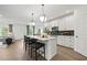 Modern kitchen with white cabinets, a center island with seating, and stainless steel appliances at 1640 Tide Mill Rd, Cumming, GA 30040