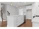 Kitchen island has stainless appliances, a double sink and hardwood floors in an open concept kitchen at 1640 Tide Mill Rd, Cumming, GA 30040