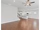 Spacious living room area that flows into a kitchen area featuring hardwood flooring and ceiling fan at 1640 Tide Mill Rd, Cumming, GA 30040