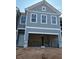 New construction home featuring a two-car garage and classic exterior details at 218 Seward St # 92, Conyers, GA 30094