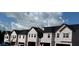 Row of new townhomes under construction with black roofs and light siding, near Seward St and Dawson St intersection at 218 Seward St # 92, Conyers, GA 30094