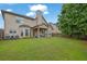 Large backyard with covered patio on a two-story home with traditional architecture at 4581 Sagebrush Ct, Snellville, GA 30039
