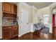 Stylish bar area featuring wood cabinets, granite countertops, and a wine rack, perfect for entertaining guests at 4581 Sagebrush Ct, Snellville, GA 30039