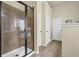 Modern bathroom with tile shower, glass door, and neutral color palette at 4581 Sagebrush Ct, Snellville, GA 30039