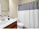 Simple bathroom features a vanity, toilet and a tub-shower with a curtain at 4581 Sagebrush Ct, Snellville, GA 30039
