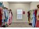 Walk-in closet with built-in shelving and plenty of storage space for clothes, hats, and shoes at 4581 Sagebrush Ct, Snellville, GA 30039