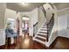 Spacious foyer featuring hardwood floors, staircase with iron balusters, and an arched doorway leading to the living room at 4581 Sagebrush Ct, Snellville, GA 30039