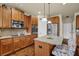 Spacious kitchen featuring stainless steel appliances, wood cabinetry, a granite-topped island, and recessed lighting at 4581 Sagebrush Ct, Snellville, GA 30039