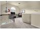 Open loft area with a window providing natural light and black metal railings at 4581 Sagebrush Ct, Snellville, GA 30039
