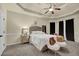 Serene main bedroom featuring a tray ceiling, soft carpet, neutral walls, and elegant furnishings at 4581 Sagebrush Ct, Snellville, GA 30039