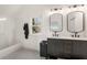 Bathroom with double vanity with modern fixtures and a tiled shower and floor at 212 Haralson Ne Ave, Atlanta, GA 30307