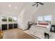 Vaulted ceiling bedroom with white shiplap, ceiling fan, and windows providing backyard views at 212 Haralson Ne Ave, Atlanta, GA 30307