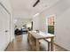 Open dining space showcasing a natural wood table, modern pendant lighting, and open layout to the living area at 212 Haralson Ne Ave, Atlanta, GA 30307