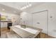 Bright dining area featuring a rustic wooden table, modern lighting, and access to the kitchen at 212 Haralson Ne Ave, Atlanta, GA 30307