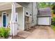 Home's exterior with driveway, green siding, and a garage in a lush neighborhood at 212 Haralson Ne Ave, Atlanta, GA 30307