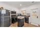 Compact kitchen featuring stainless steel appliances, modern fixtures, and a light-filled door at 212 Haralson Ne Ave, Atlanta, GA 30307