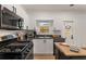 Stylish kitchen features stainless appliances, white cabinetry, and a movable island at 212 Haralson Ne Ave, Atlanta, GA 30307