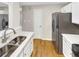 Spacious kitchen featuring stainless steel appliances, white cabinets, and a double sink at 2190 River Heights Se Ct, Marietta, GA 30067
