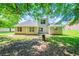 View of a multi-story home featuring neutral siding and a well-maintained backyard with lush green grass at 297 Edison Dr, Stockbridge, GA 30281